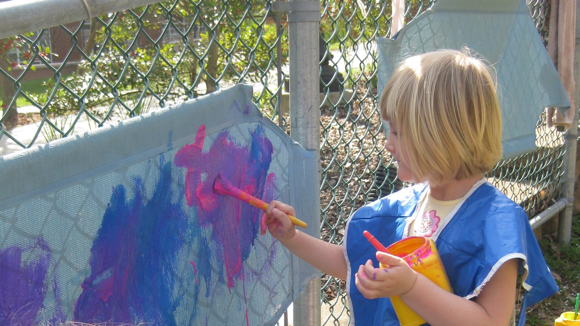 Children painting outside at UNCG's Childcare Program