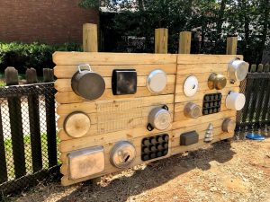 a wooden wall with pots and pans hanging on it - a music wall